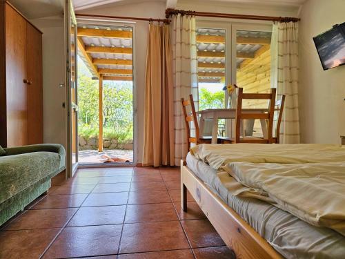 a bedroom with a bed and a table and chairs at Pod Jesionem in Lubin