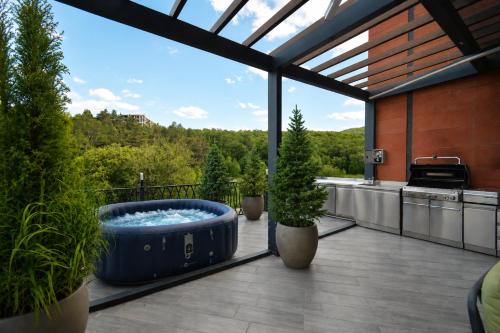 a large blue tub on a balcony with potted plants at Domel Tsaghkadzor in Tsaghkadzor