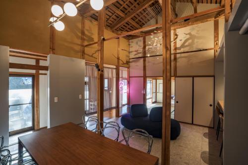 a living room with a table and a couch at MITAMA House 01 ミタマ ハウス 01 in Ise