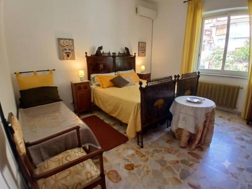 a bedroom with a bed and a table in it at At Armando's Home in Zafferana Etnea