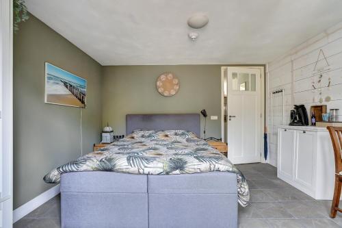 a bedroom with a bed in the corner of a room at By Onzz in Kamperland