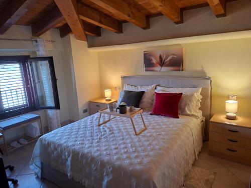 a bedroom with a large bed with a table on it at LOCAZIONE TURISTICA Camere De Vito in San Salvo