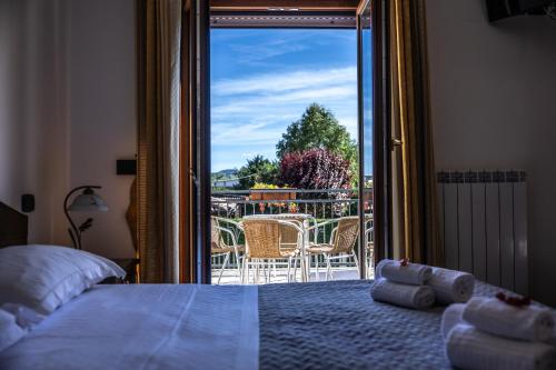 a bedroom with a bed and a view of a balcony at River Hotel in Castel di Sangro