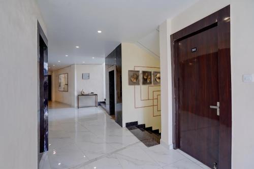 a hallway of a house with a door and a staircase at FabHotel Crystal Zee in Kānpur