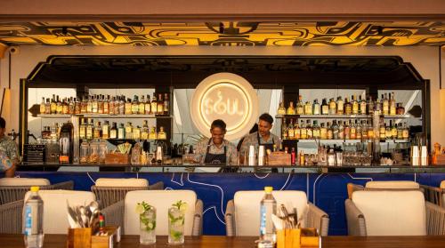 two men standing behind a bar in a restaurant at The Sierra - By The Lake in Udaipur