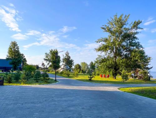 a road in a park with trees and grass at Morewell Resort&SPA in Tolokun