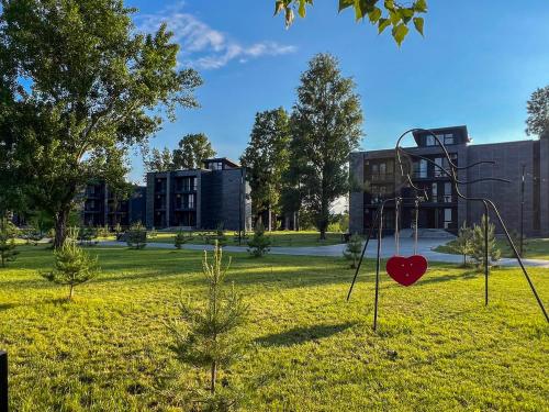 a playground with a swing in a park at Morewell Resort&SPA in Tolokun