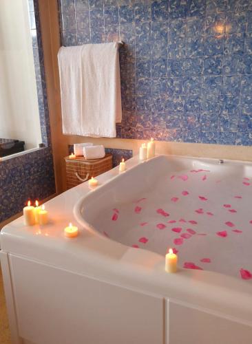 a bathroom with a tub with candles in it at Lighthouse Apartment in Luz