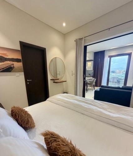 a bedroom with a large bed and a window with a view at Segal 2 Hawana Salalah Forest Island in Salalah