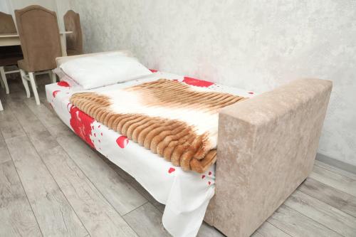 a bed with a blanket on it in a room at SunRise in Masazır