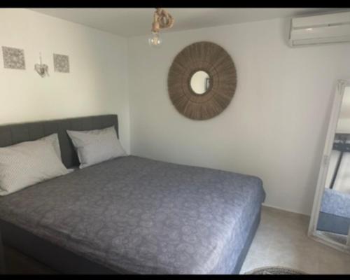 a bedroom with a bed and a mirror on the wall at Agathe Haus in Stavros