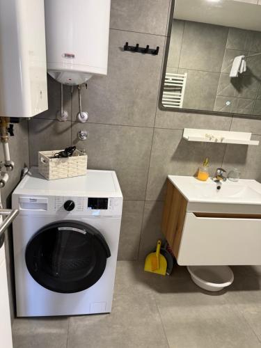 a kitchen with a washing machine and a sink at PRESTIGE apartman Krusevac in Kruševac