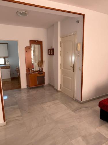 an empty living room with a door and a tile floor at Piso Tamaragua in Arrecife