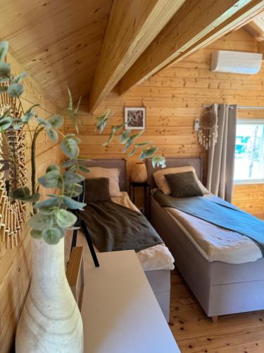a bedroom with two beds in a log cabin at Koochill in Koczała