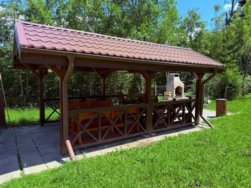 a wooden gazebo with a red roof at Ideal Predeal in Predeal