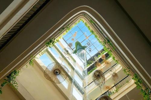 a window in a building with a statue in it at Amsphere Homestay & Restaurant in Hanoi