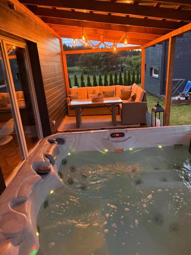 a jacuzzi tub in the backyard of a house at Koochill in Koczała