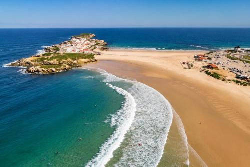 an aerial view of a beach and the ocean at Kampaoh Peniche in Peniche