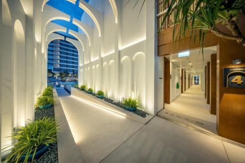 a hallway of an office building with plants at Patong Beach Hotel by See2Sea in Patong Beach