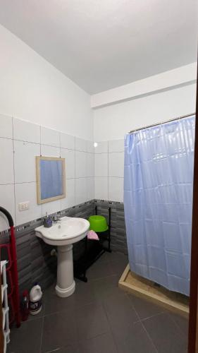 a bathroom with a sink and a shower at Casa Vlora in Vlorë