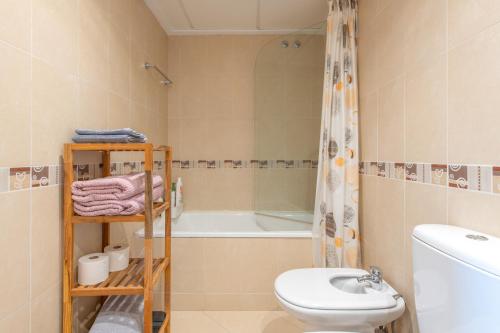 a bathroom with a toilet sink and a bath tub at Apartment In Golf Mar Resort in San Jorge