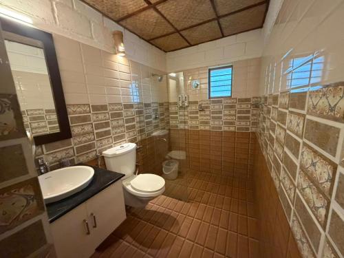 a bathroom with a toilet and a sink at Sumeru valley vagamon in Idukki