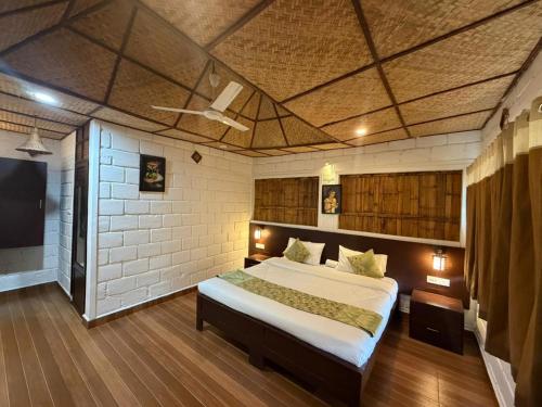 a bedroom with a large bed with a ceiling at Sumeru valley vagamon in Idukki