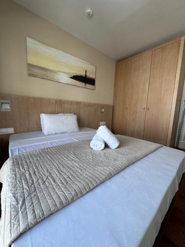 a bedroom with two beds with white pillows on them at ACP Cambrils Puerto Apartamentos in Cambrils