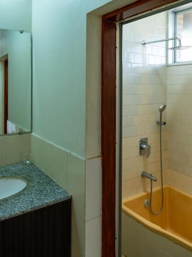 a bathroom with a sink and a bath tub at Hokke Lumbini in Rummindei