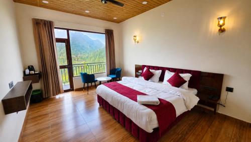 a bedroom with a large bed and a large window at Dharamshila Retreat in Chakrāta