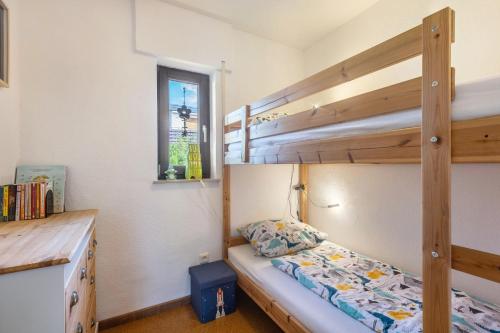 a bedroom with two bunk beds and a desk at Ferienwohnung Talblick in Medebach