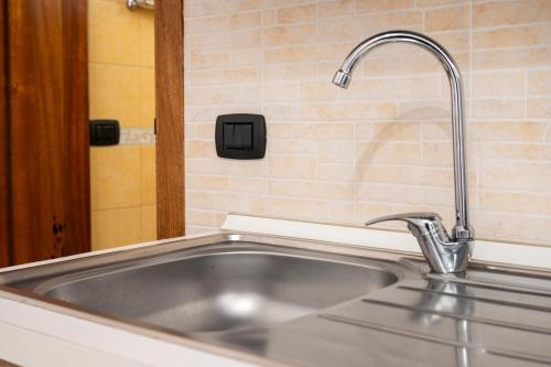 a kitchen sink with a faucet on top of it at Lu Marchese in Minervino di Lecce