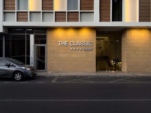 a building with a sign on the side of it at The Classic Hotel Nicosia - Handwritten Collection in Nicosia