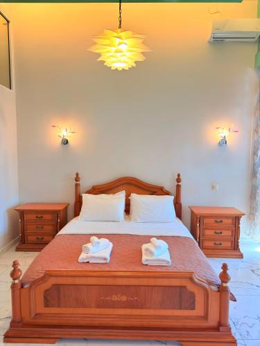 a bedroom with a bed with two towels on it at Premier Sea Apartment in Paleo Tsifliki