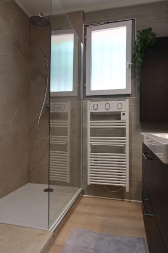 a bathroom with a shower with a glass shower backdoor at La Vilo Dòu Verdon in Roumoules