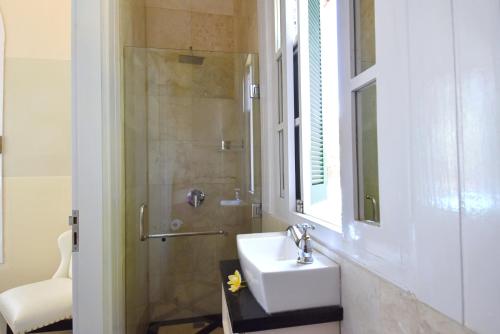 a bathroom with a sink and a shower at Villa Mimosa in Lovina