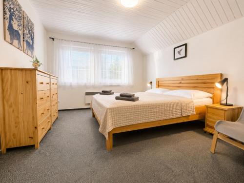 a bedroom with a large bed and a window at Chata Markétka in Dobré