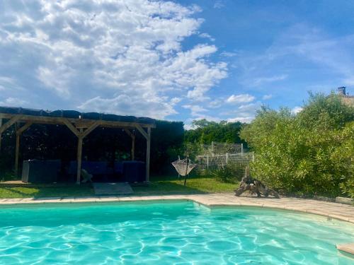 a swimming pool in a yard with a gazebo at Loue appartement avec jardin in Alba-la-Romaine