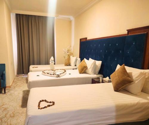 a hotel room with two beds and avisor at Vivian AL Shasha in Mecca