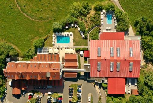 an aerial view of a house with red roofs at FAIR RESORT All Inclusive Wellness & Spa Hotel Jena in Jena