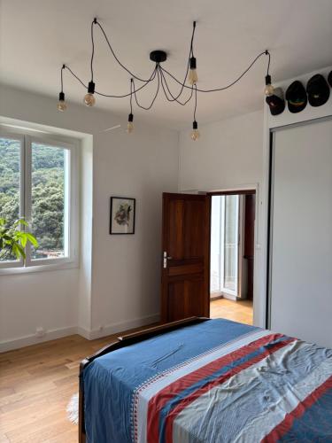 a bedroom with a bed and a chandelier at Village vacations in Guarguale