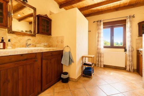 a bathroom with a sink and a tub and a window at Cozy vacation home in Alfaz del Pi