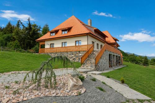a house on a hill with a garden in front of it at ROGOChalet in Rogojel
