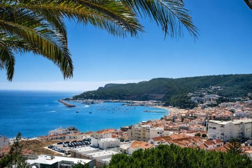 a view of a city and the ocean at Kampaoh Sesimbra in Sesimbra