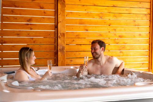 a man and a woman sitting in a bath tub at Chata Markétka in Dobré