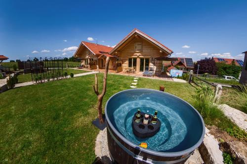 a cat in a bath tub in a yard at Chalets Waldeck - Urlaub im Fränkischen Seenland und Altmühltal in Raitenbuch