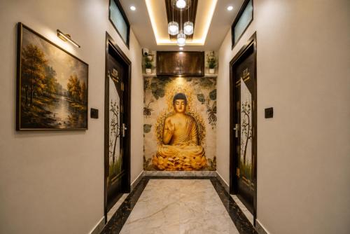 a hallway with a large buddha painting on the wall at Hotel The RG Grand Inn Near Chandigarh Railway Station in Chandīgarh