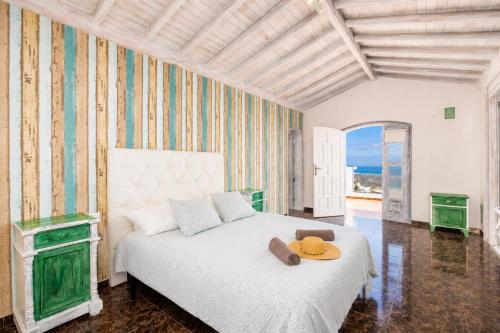 a bedroom with a bed with a hat on it at Villa Oasis de Asomada in La Asomada