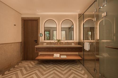 a bathroom with a sink and a mirror at Sakhra Hotel & Spa, Almaza Bay in Marsa Matruh
