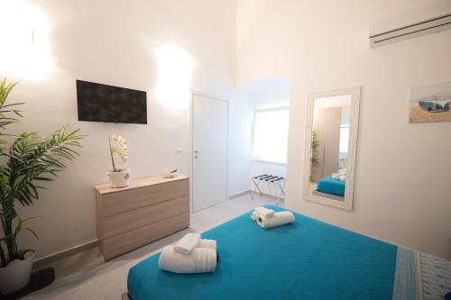 a bedroom with a blue bed and a mirror at La VILLA in Modugno